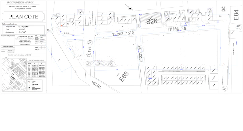 Designer marking up a hand-drawn site plan spread across a truck tailgate