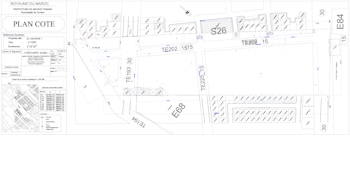 Architectural or urban planning layout with labeled sections and codes. It includes detailed dimensions, various structural elements, streets, and plot numbers. There are also annotations and technical notes.
