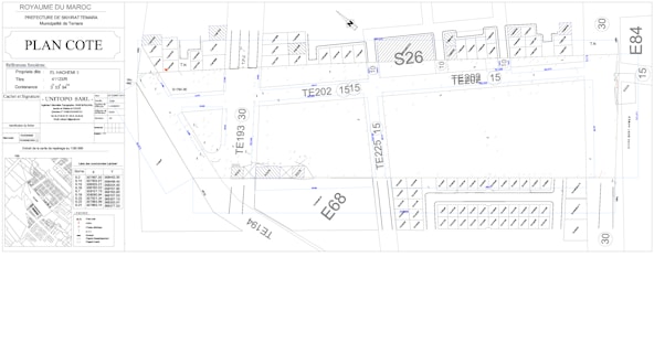 Architectural or urban planning layout with labeled sections and codes. It includes detailed dimensions, various structural elements, streets, and plot numbers. There are also annotations and technical notes.