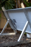 Close-up of solar panel connections being secured with tools.