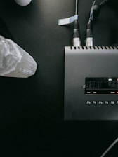 a black table with a radio and some wires