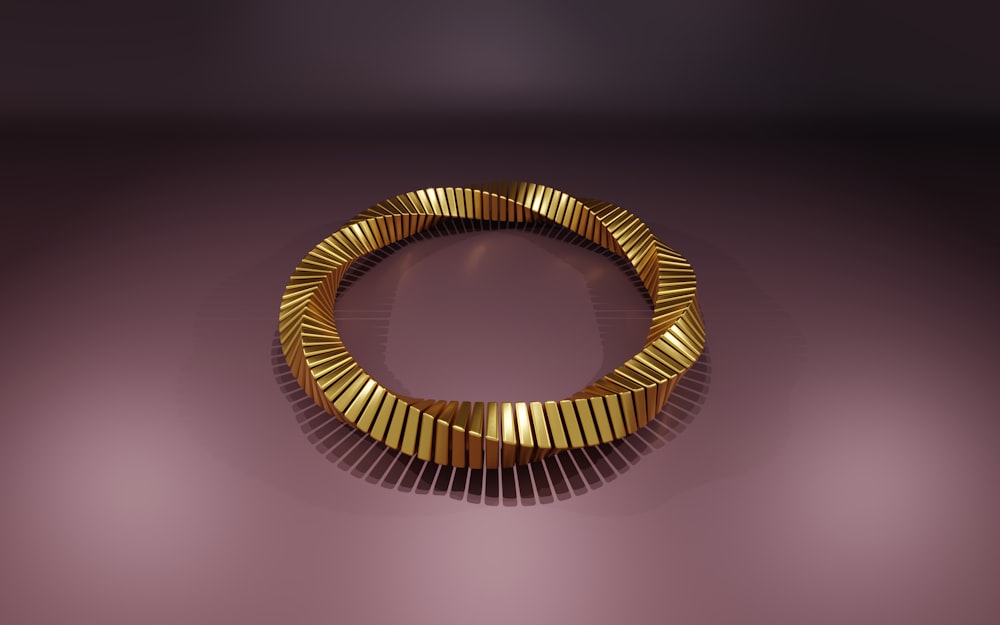 a gold bracelet on a purple background