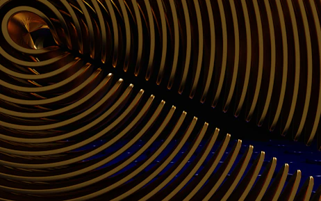 A sleek, brushed gold geometric pattern overlaying a deep midnight blue background, evoking cosmic energy.