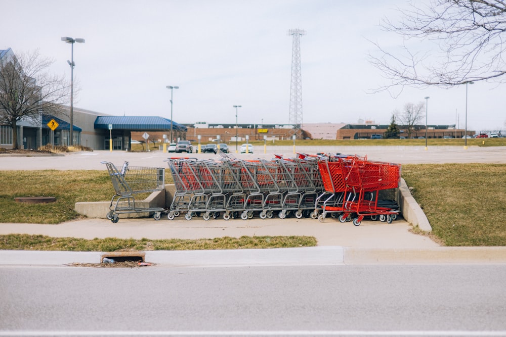 a row of shopping carts sitting on the side of a road