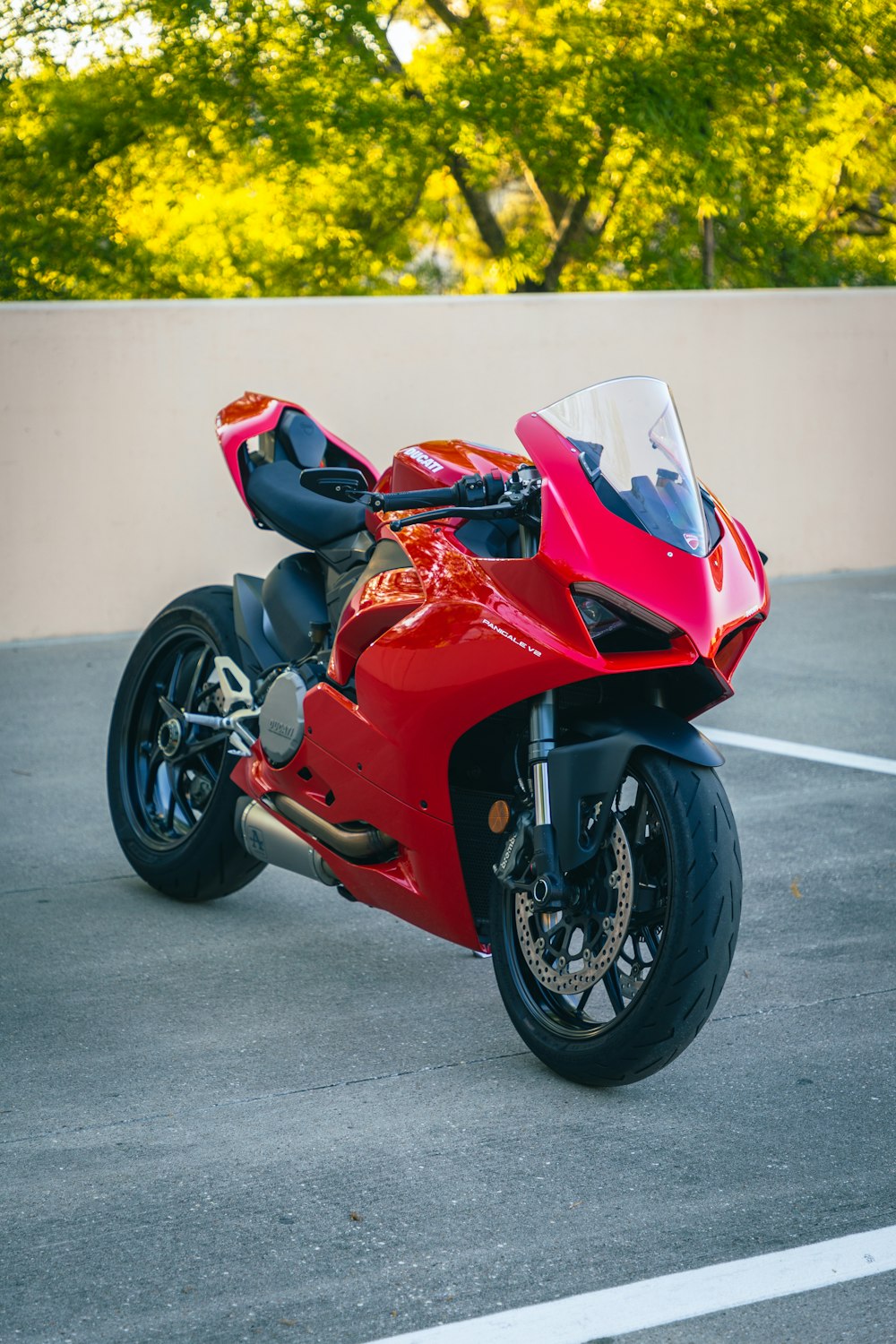 a red motorcycle parked in a parking lot