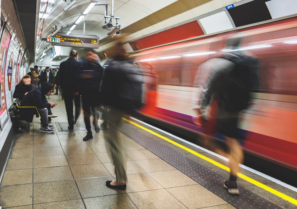 a group of people waiting on a subway platform