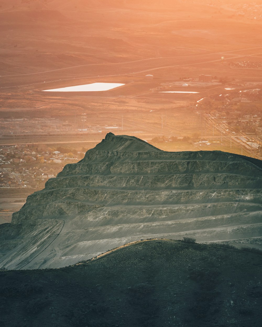 a view of a mountain with a sunset in the background