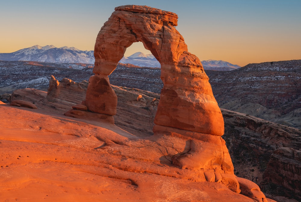 a large rock formation in the middle of a desert