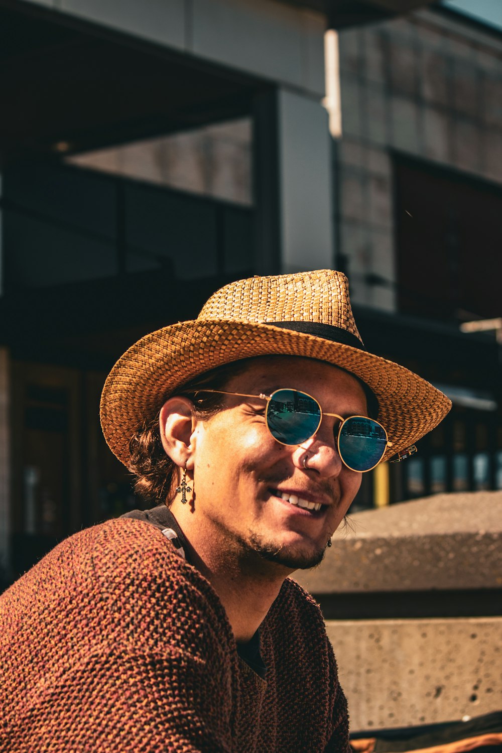 a man wearing a straw hat and sunglasses