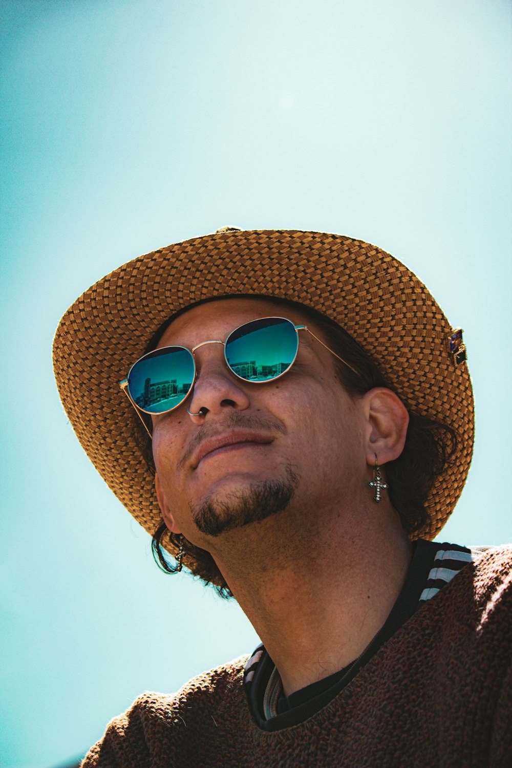 a man wearing a straw hat and sunglasses