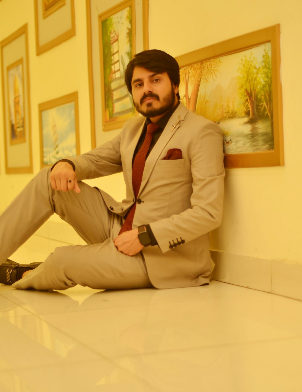 a man in a suit sitting on the floor