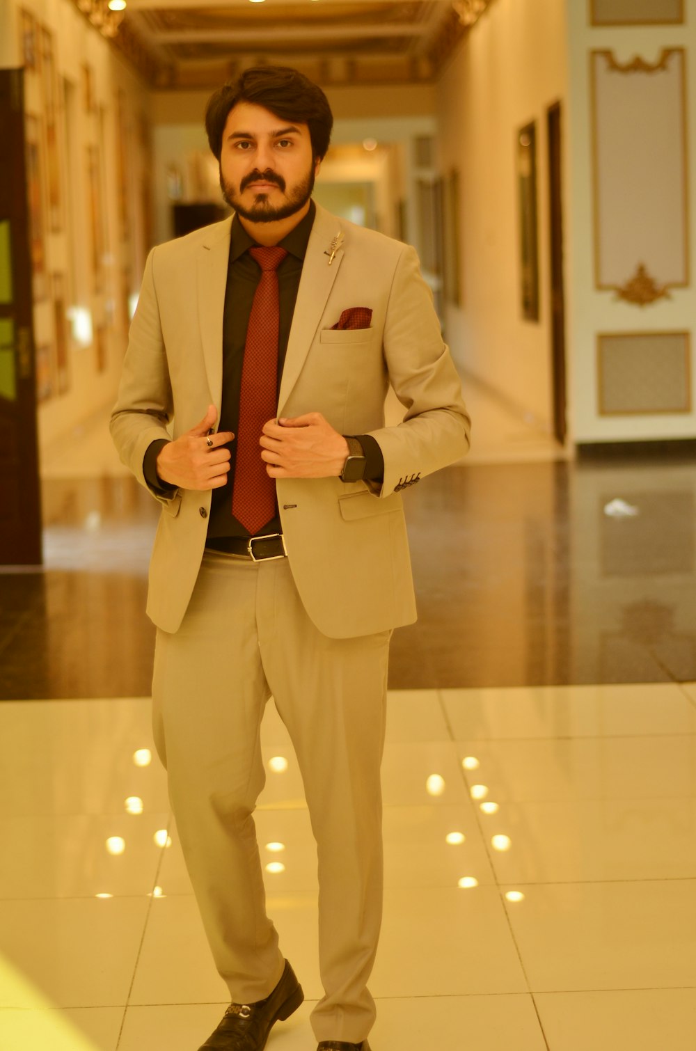 a man in a suit and tie standing in a hallway