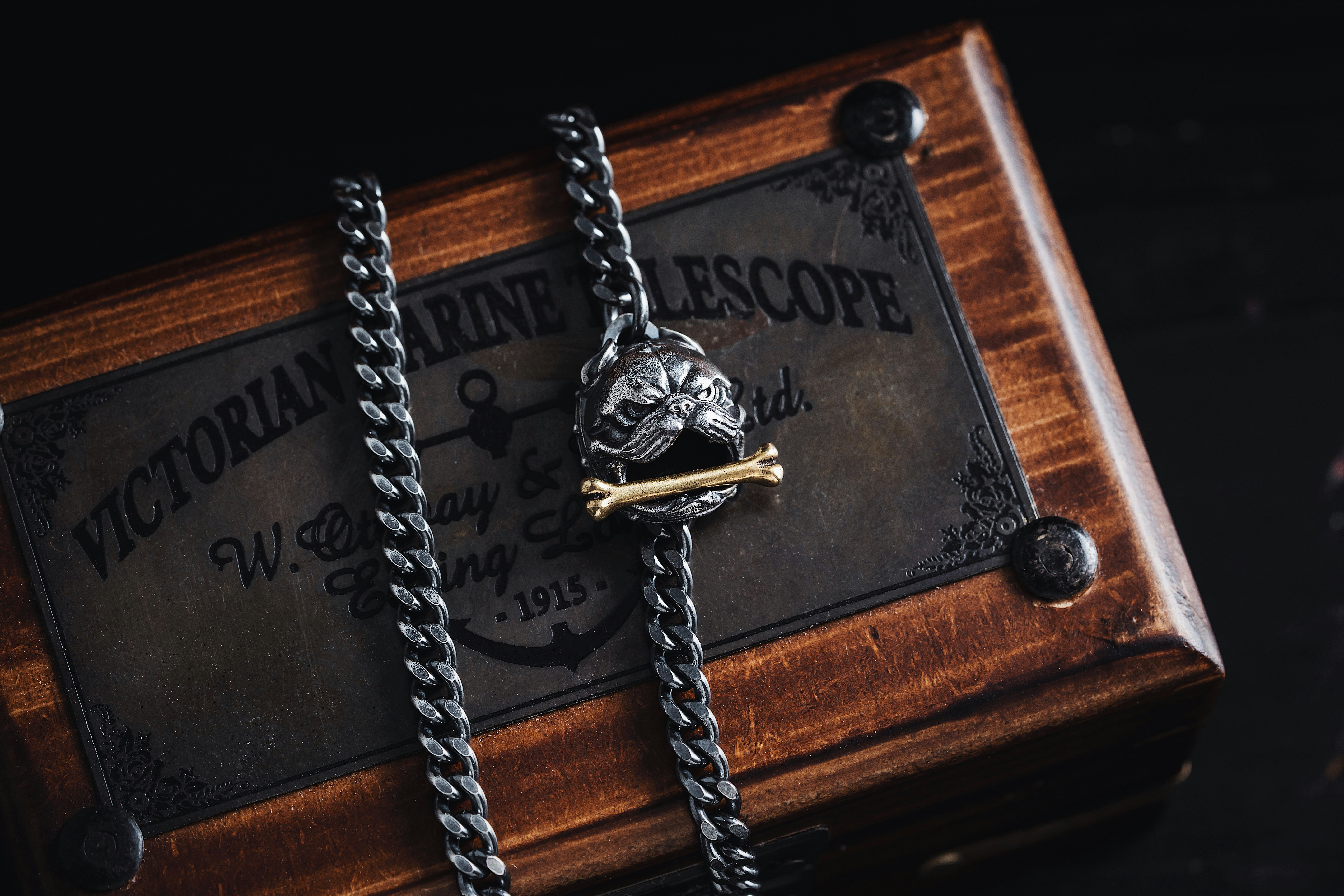 a wooden box with two chains attached to it