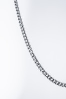 A close-up of a polished, metallic chain against a plain, light background. The chain appears to be made of interlocking loops that form a pattern.