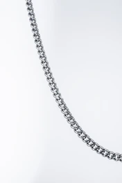 Close-up of a polished silver chain catching light against a dark background.