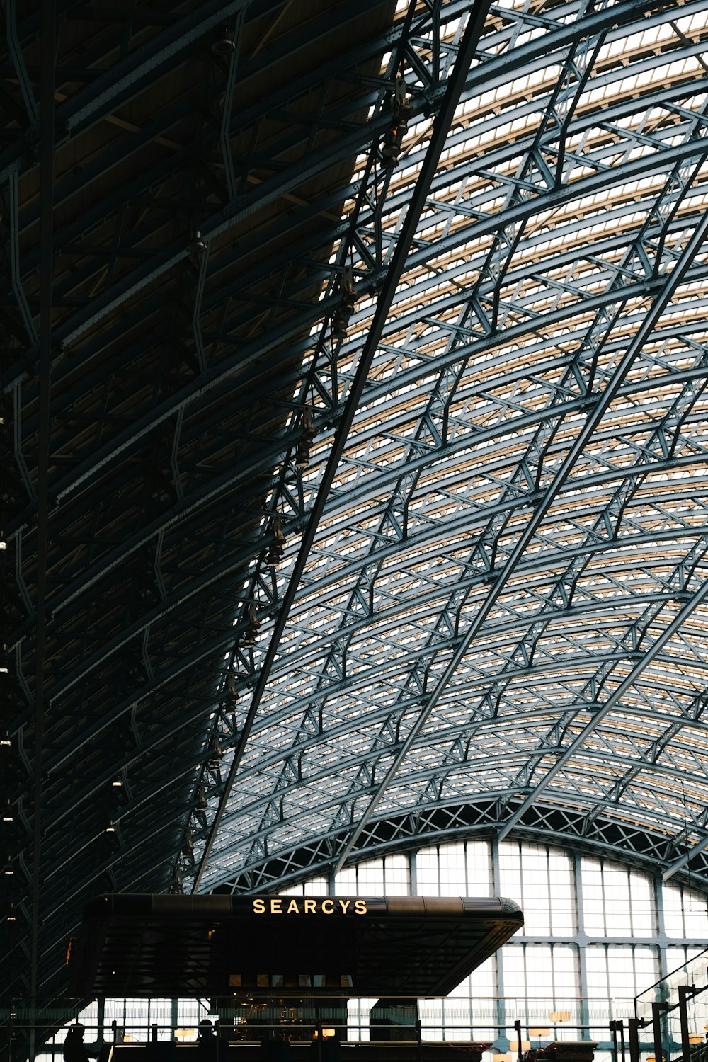 a train station with a large metal roof