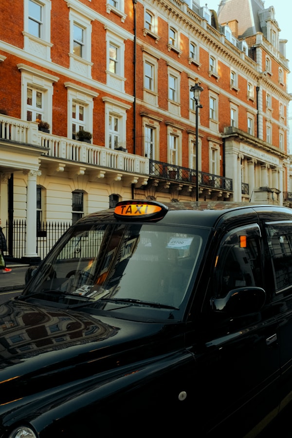 Black taxi cab near a London building
