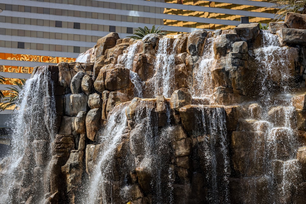 a large waterfall in front of a hotel