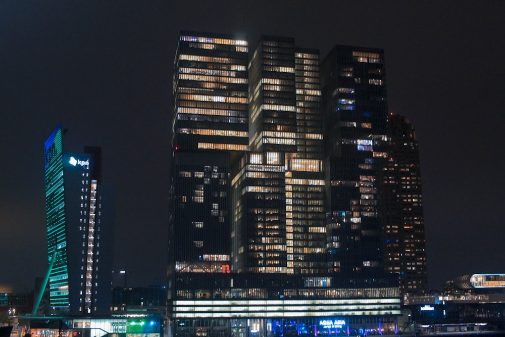 a very tall building sitting next to a body of water