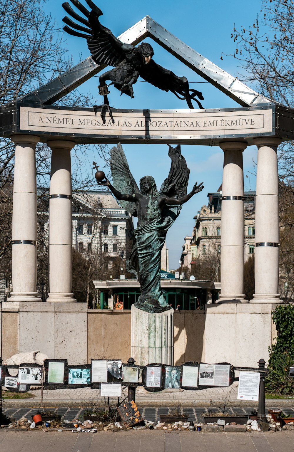 a statue of a woman holding a bird in front of a building