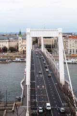 A large bridge spanning a wide river, with vehicles crossing smoothly.