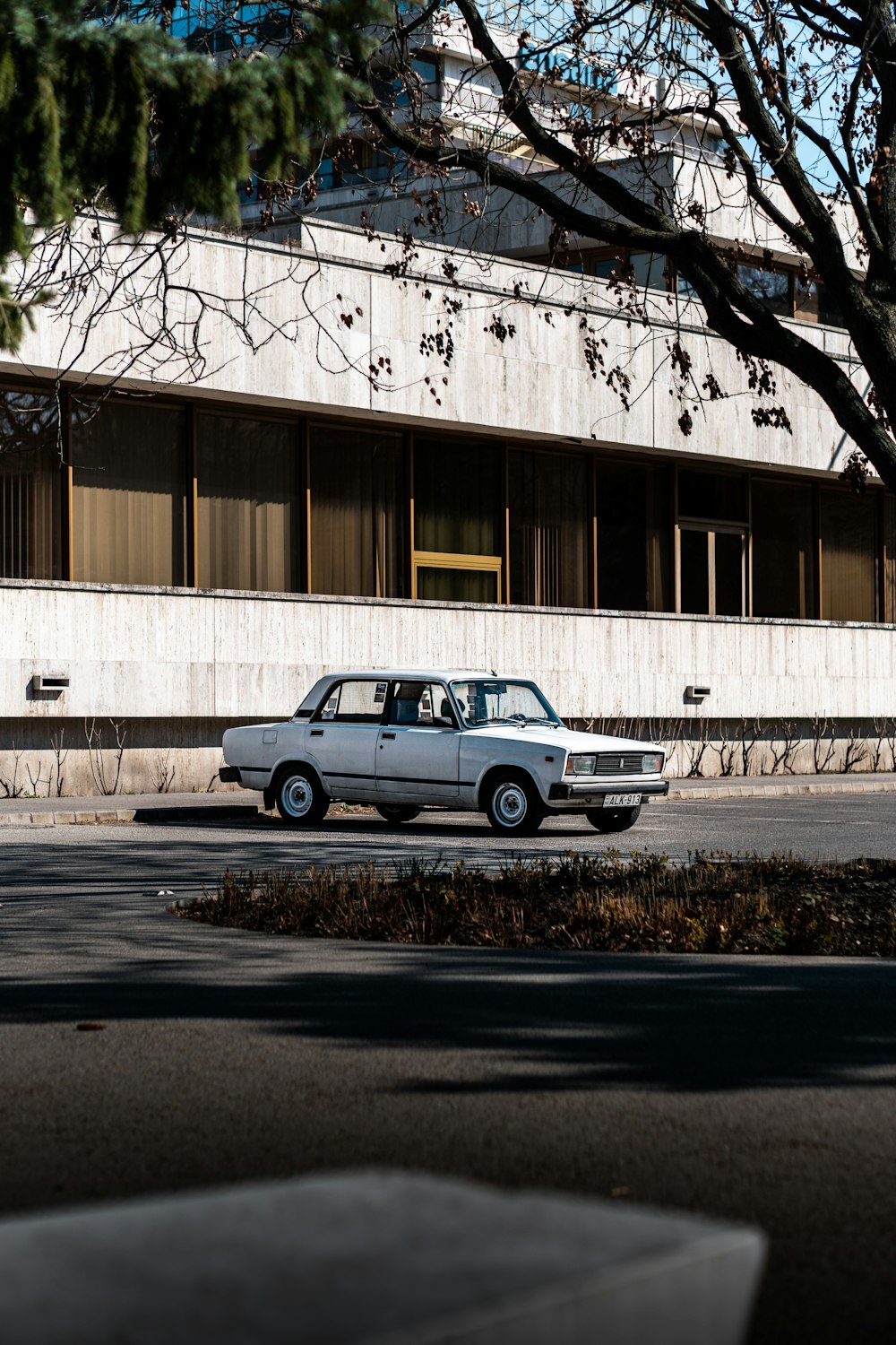 a white car parked in front of a building