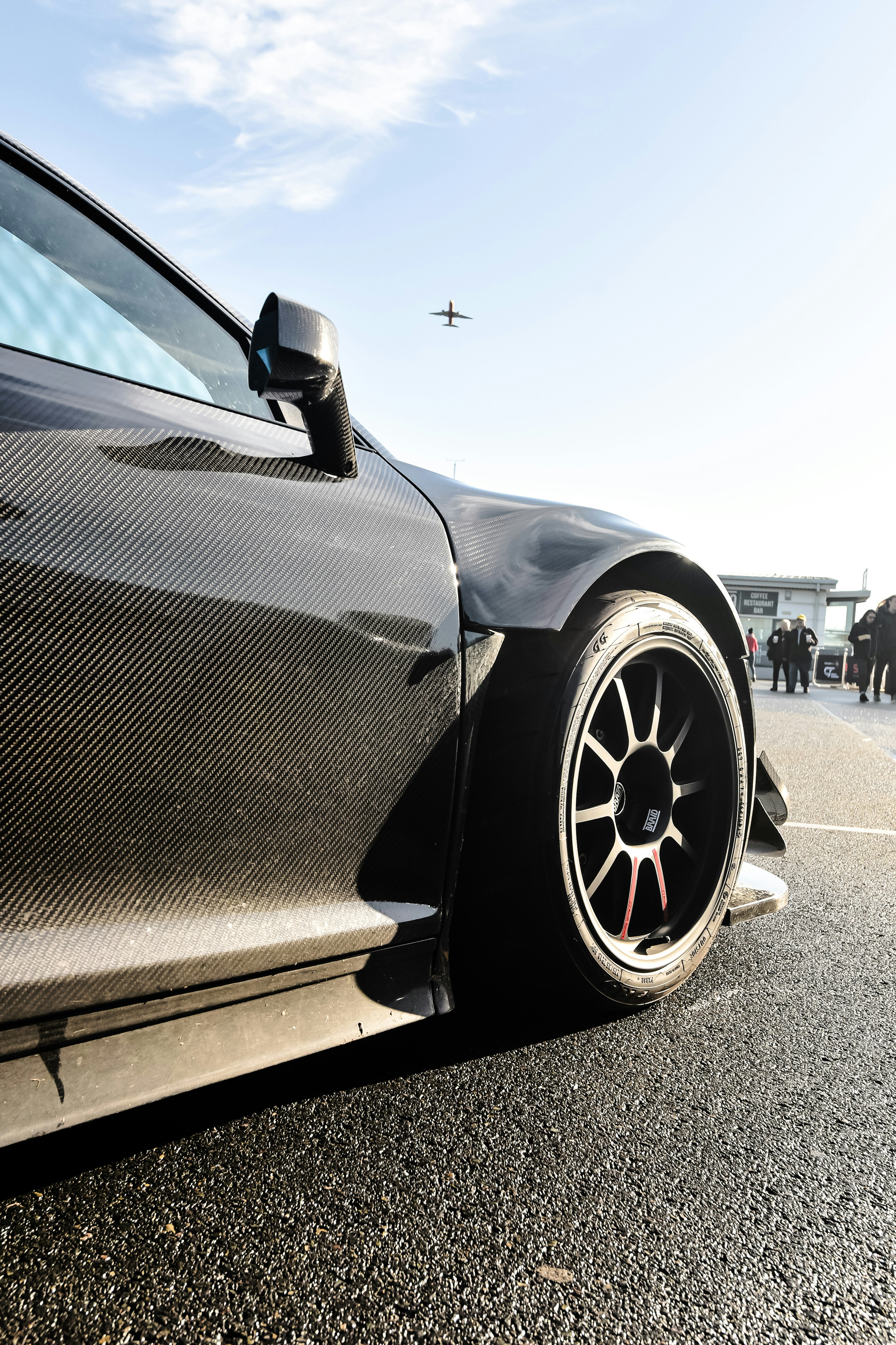 a black sports car parked in a parking lot