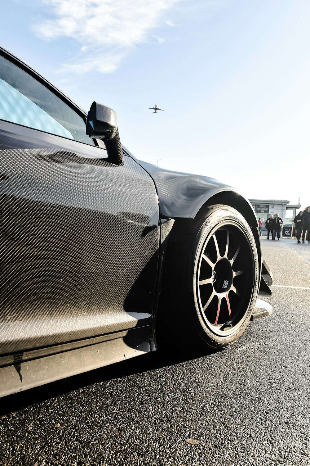 a black sports car parked in a parking lot