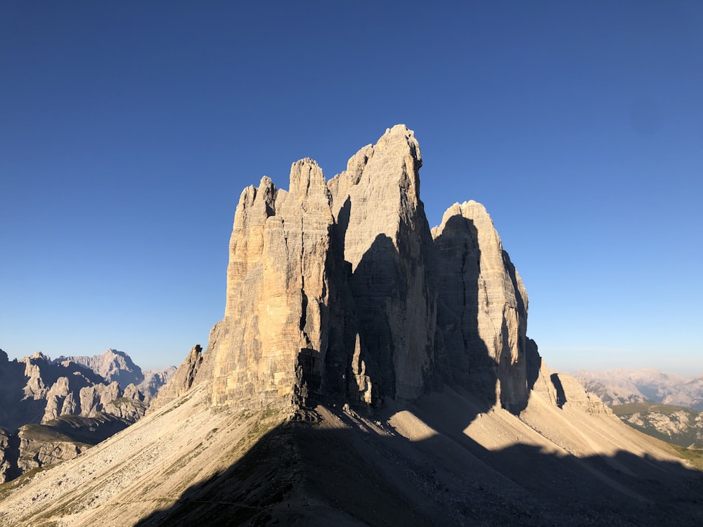 a large mountain with a very tall rock formation