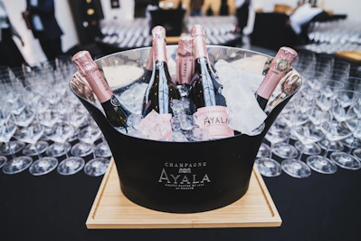 a bucket filled with bottles of champagne on top of a table