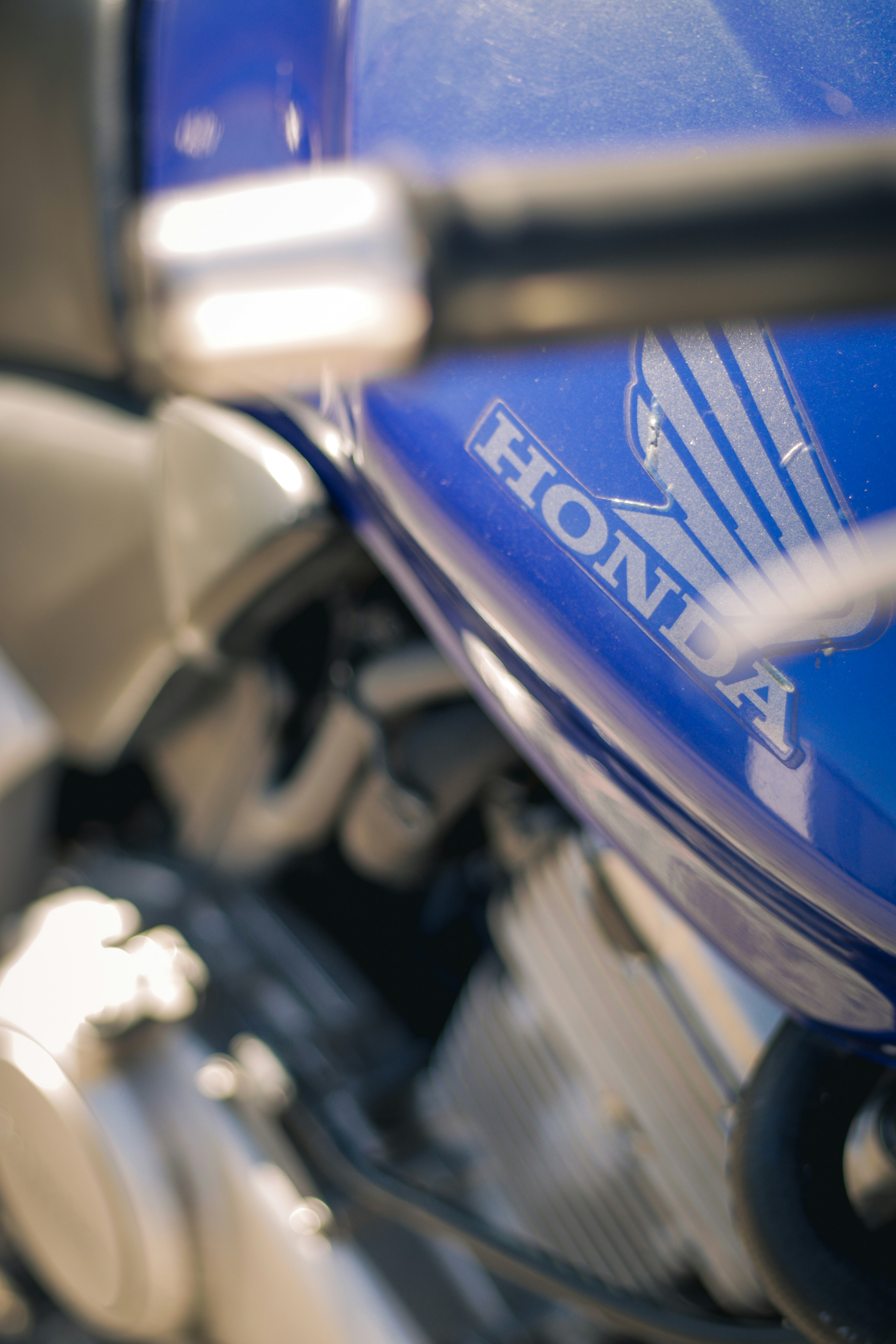 a close up of a blue motorcycle engine