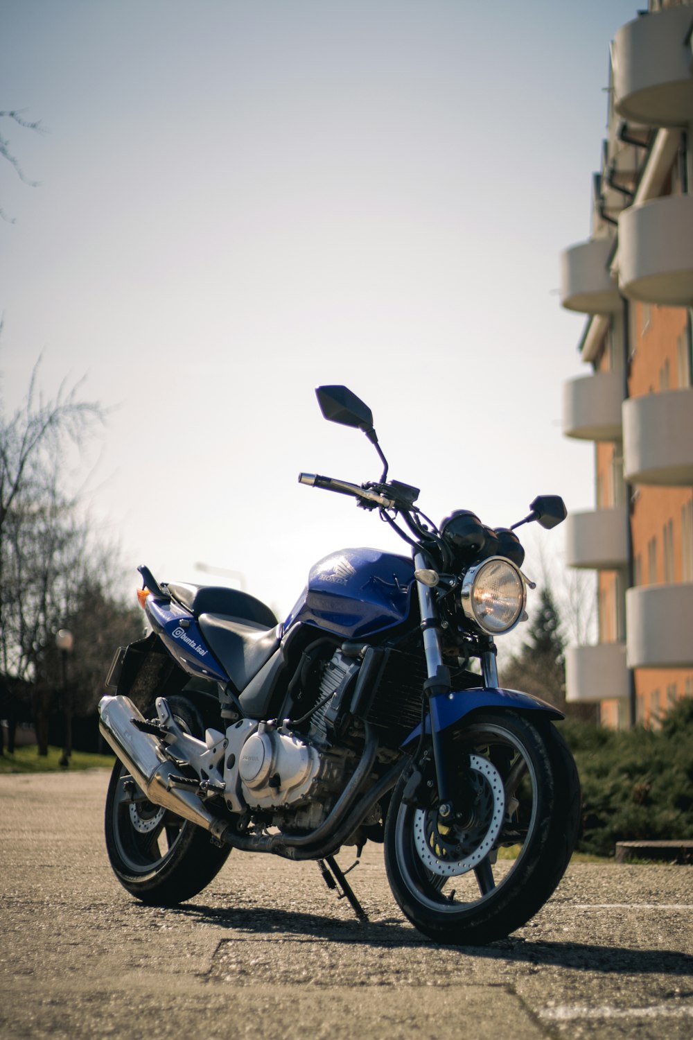 a blue motorcycle parked in front of a building
