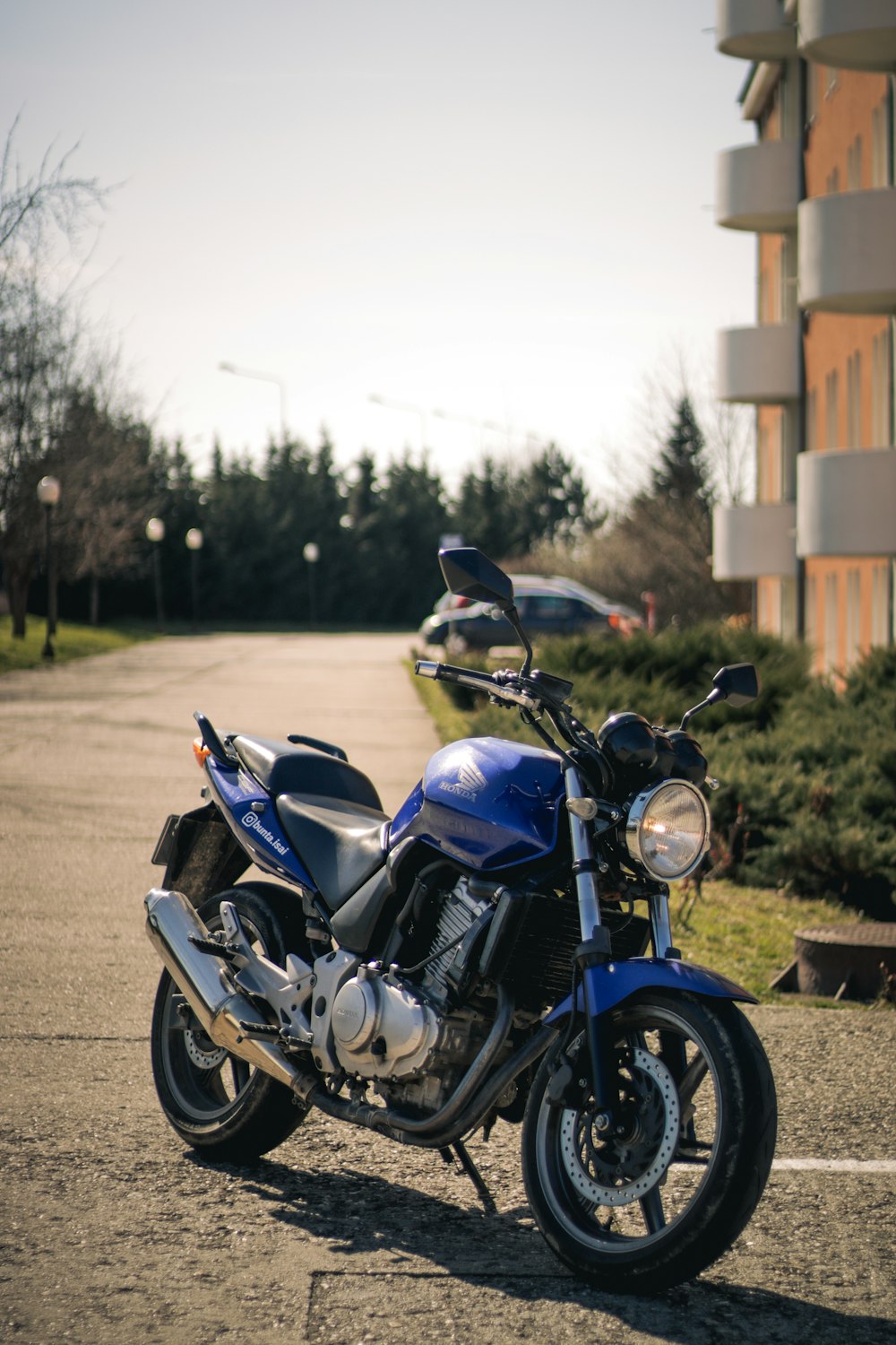 a blue motorcycle parked in a parking lot