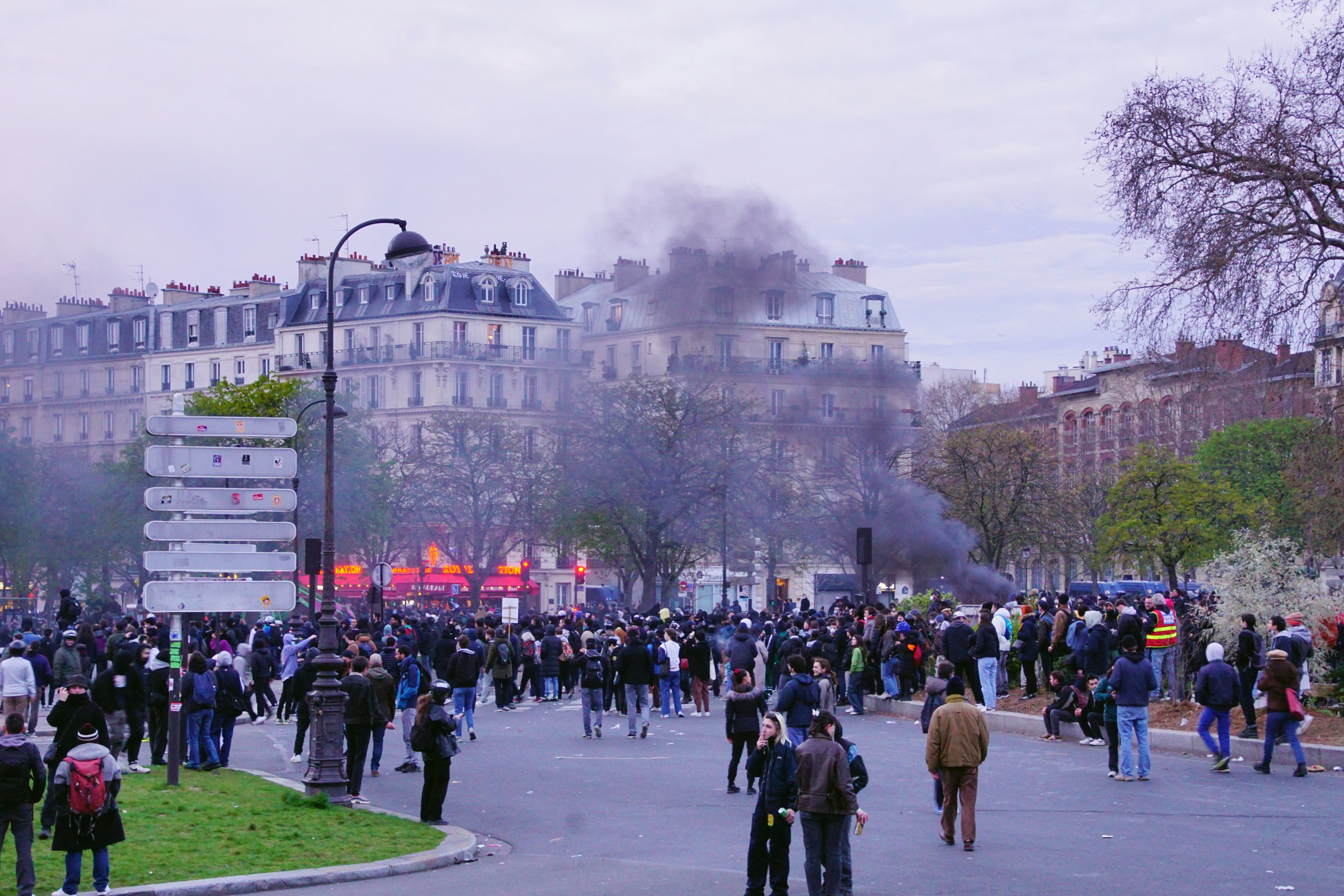 a large group of people walking around a street