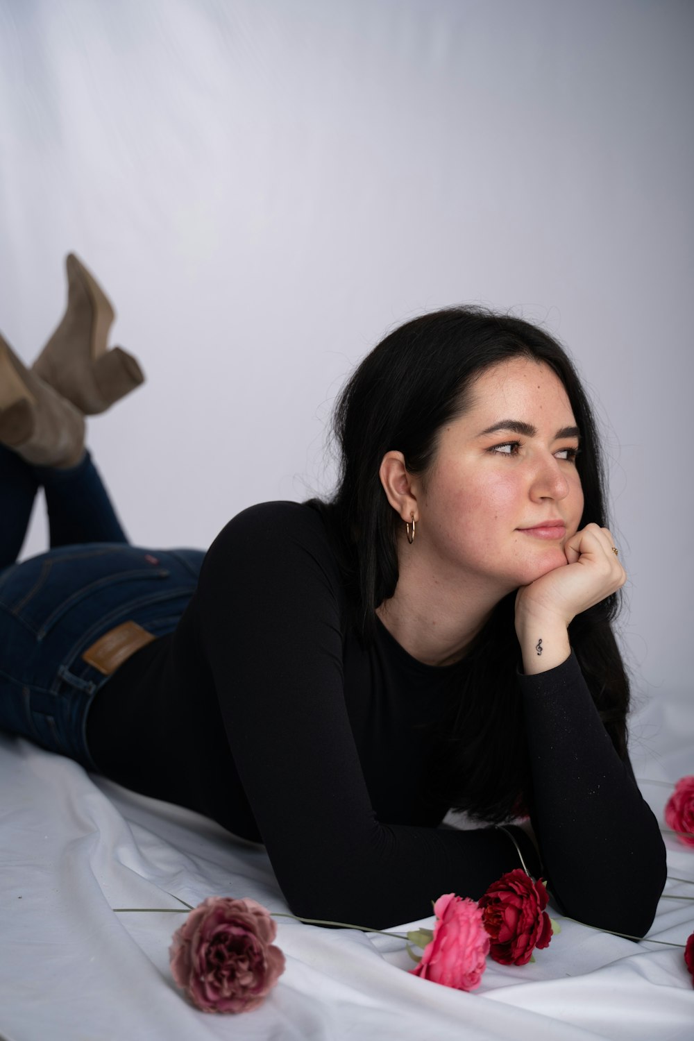 a woman laying on a bed of roses