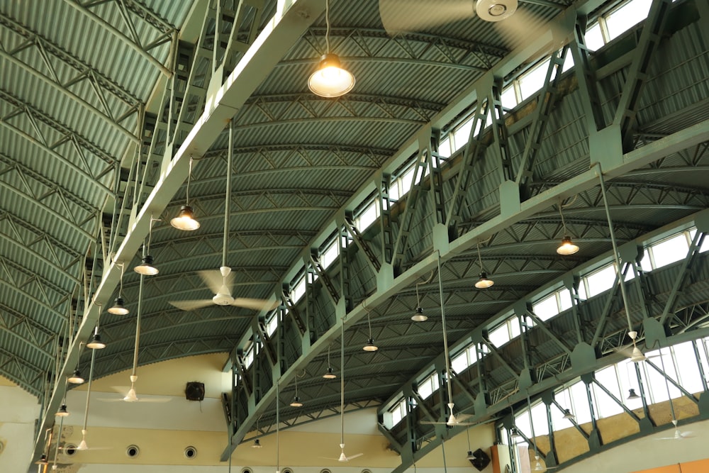 the ceiling of a large building with a ceiling fan