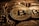 A close-up view of multiple shiny gold coins featuring the Bitcoin logo with intricate circuit-like patterns. The coins are stacked and overlap each other, creating a sense of abundance and wealth.