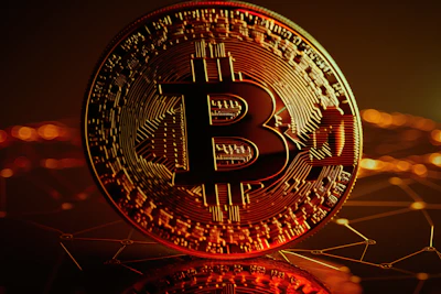 Abstract blockchain network visualization in deep blue and black tones with glowing bitcoin symbols.