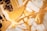 Intricate patterns of gold and white marble with rich veins, creating an abstract and luxurious visual texture.