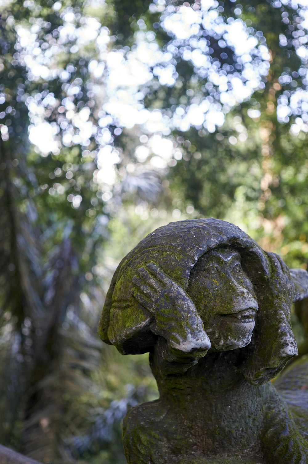 a statue of a woman holding her head in her hands