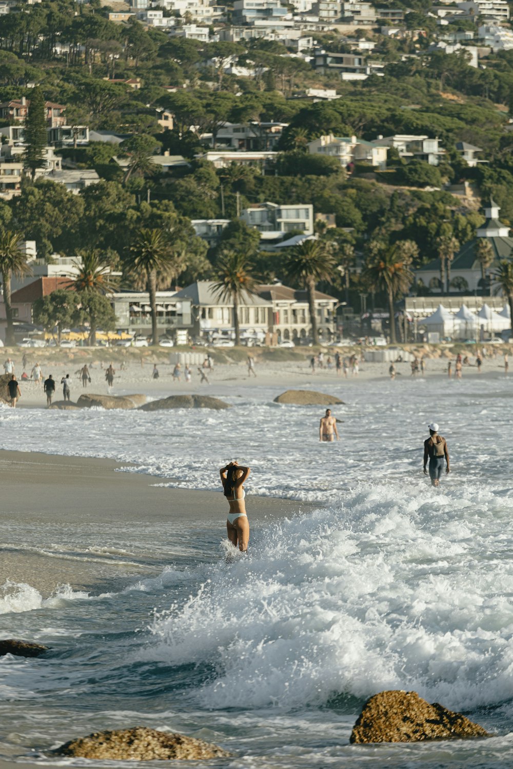 a group of people standing on top of a sandy beach