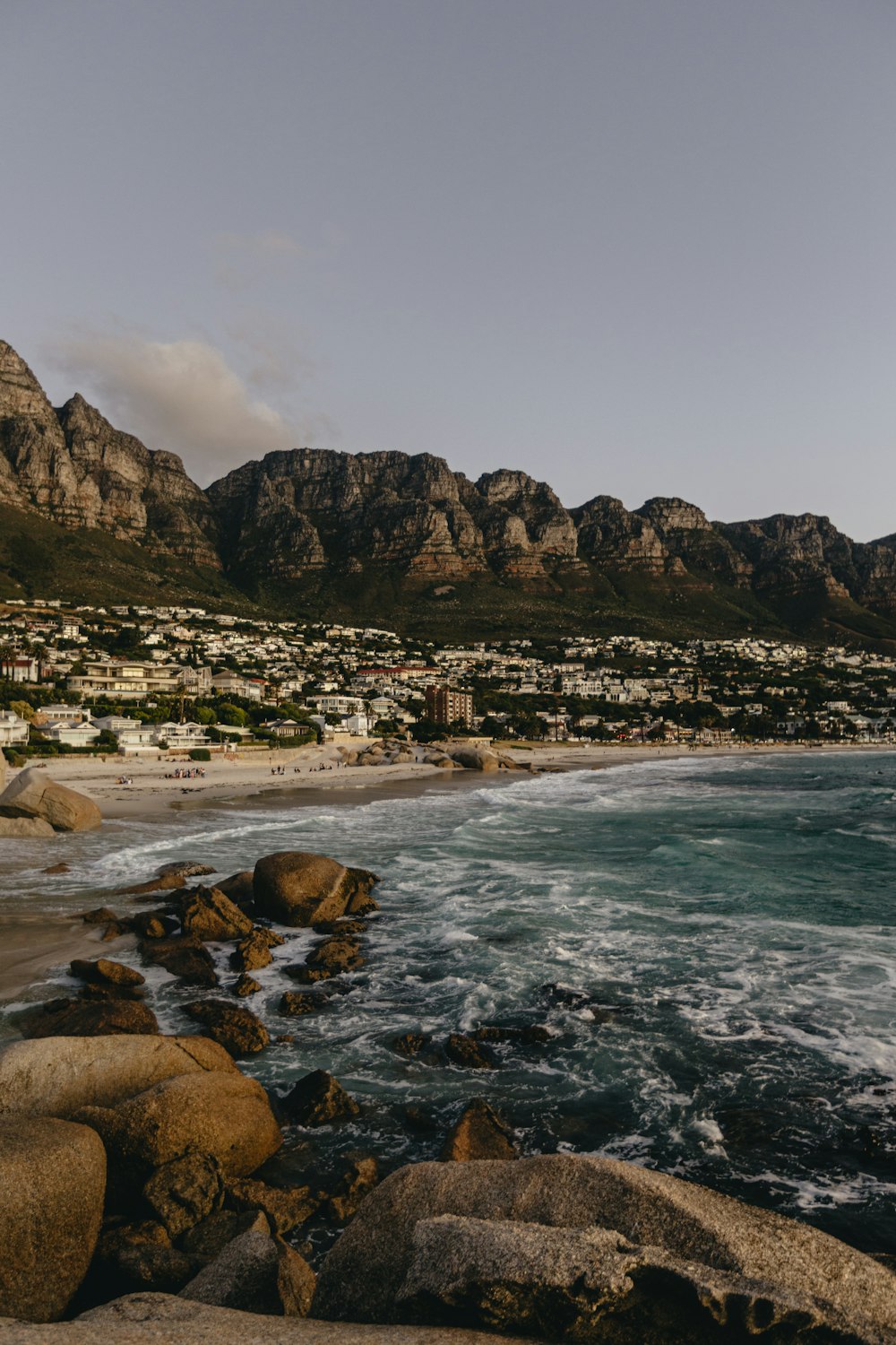 a view of a beach with mountains in the background