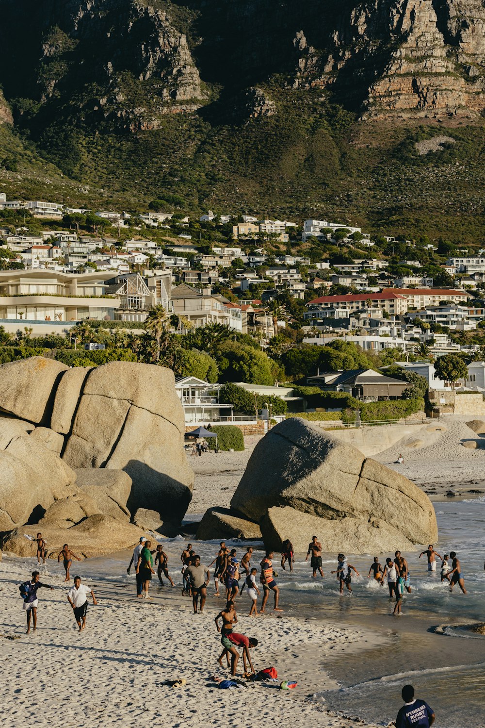 a group of people standing on top of a sandy beach