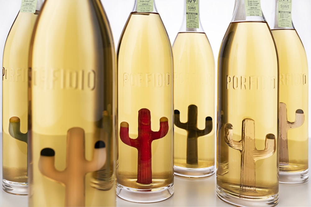 a group of bottles of wine with a cactus in them