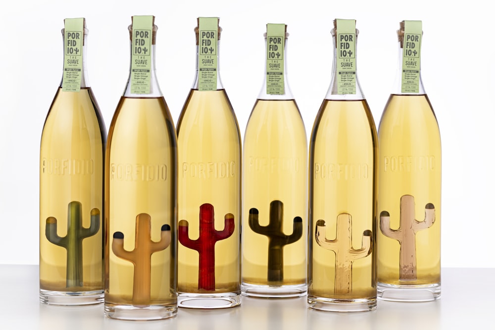 a row of wine bottles with different designs on them