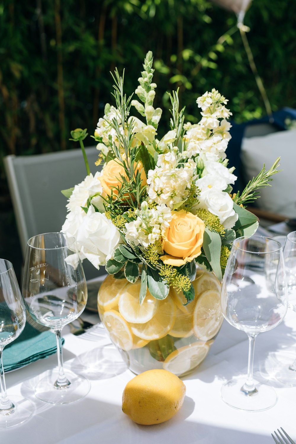 a vase filled with yellow and white flowers on top of a table