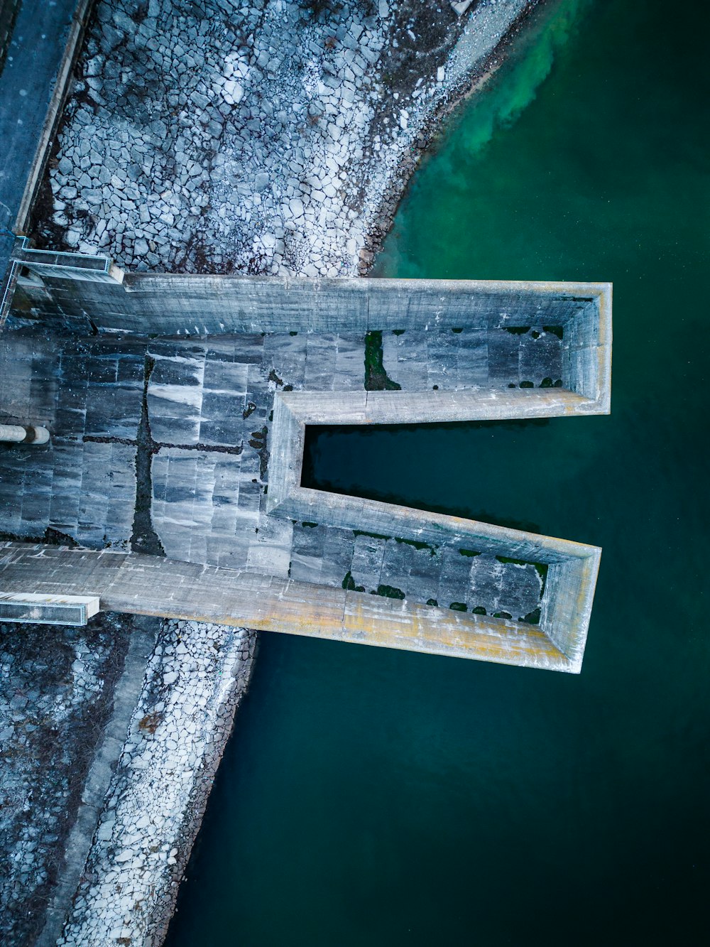 an aerial view of a bridge over a body of water