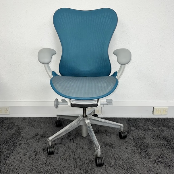 A gel office chair mat placed under a sleek desk chair, showing its smooth surface and ergonomic design.