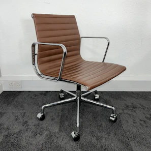 A classic leather executive chair with padded armrests and high backrest.