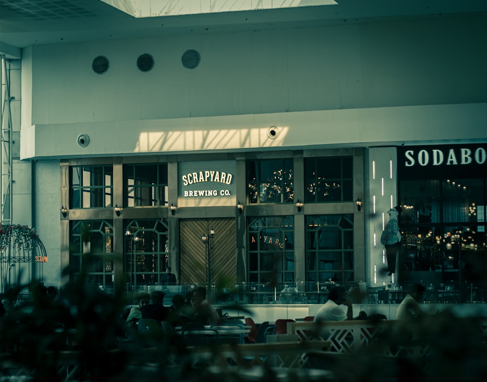 a restaurant with people sitting at tables outside